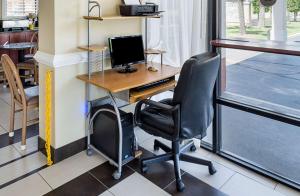 an office with a desk with a computer and a chair at Rodeway Inn Panama City in Panama City