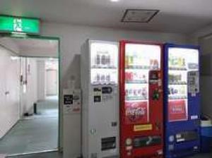 a gas station with two machines in a room at Green Hotel Shimonoseki in Shimonoseki