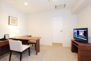 a living room filled with furniture and a tv at Tokyu Stay Shibuya in Tokyo