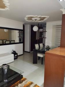 a living room with a table and a desk at Supercondo Home Away From Home mi Casa Tu Casa in Cali +48 photos