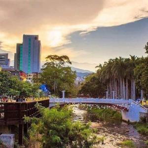 a bridge over a river in a city at Supercondo Home Away From Home mi Casa Tu Casa in Cali