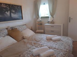 a bedroom with a large bed with two pillows on it at Apartments Garden Monsena in Rovinj