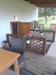 a patio with chairs and a table with flowers on it at Apartments Garden Monsena in Rovinj
