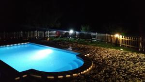 a swimming pool in a yard at night at Mas de Salvador in Peñarroya de Tastavins