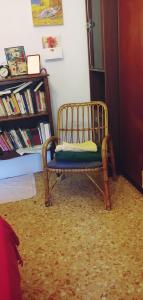 a chair with a pillow on it in a room at CozyandCalm in Florence