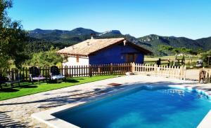 a swimming pool in front of a house at Mas de Salvador in Peñarroya de Tastavins