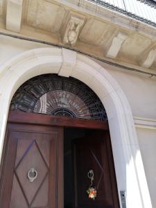 an archway over a wooden door in a building at L'Antico Pergolato Apartments in Brindisi