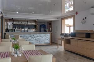 a dining room with a bar and a table and chairs at Przystanek Alaska in Zieleniec +8 photos