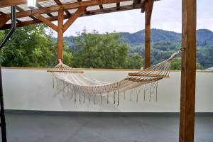 a hammock hanging from a pergola with a view at Lavand House in Vişeu de Sus +68 photos