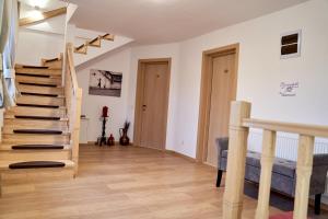 a living room with stairs and a blue couch at Lavand House in Vişeu de Sus