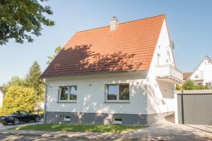 a white house with an orange roof at Location 1 in Rimschweiler