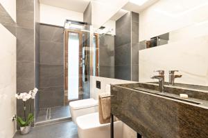 a bathroom with a sink and a toilet at First Class Rome Apartments in Rome +37 photos