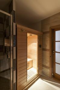 een inloopdouche in een badkamer met houten wanden bij Apartman Zacler v Krkonosich in Žacléř