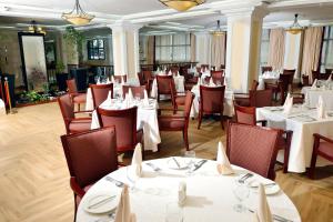 a dining room with white tables and chairs at The HUB Hotel in Addis Ababa