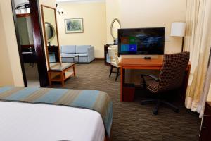 a hotel room with a bed and a desk with a computer at The HUB Hotel in Addis Ababa