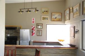 a kitchen with a counter and a refrigerator at SelkieBnB in Walvis Bay