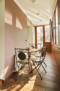 a dining room with a table and two chairs at APARTMENT IN DERIBASOVSKAY STREET 20 in Odesa