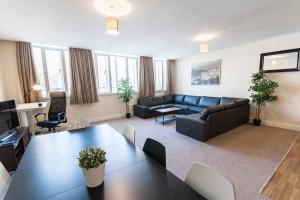 a living room with a couch and a table at The Broadmead Forest - Spacious City Centre 3BDR Apartment in Bristol