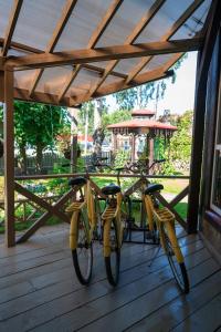 two yellow bikes are parked on a porch at Guest House Blizhnie Dubki in Saint Petersburg