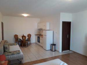 a living room with a couch and a refrigerator at Apartments Dalmacija in Podstrana