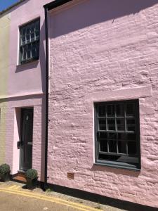 a pink building with two windows at Boutique Townhouse in Christchurch Dorset in Christchurch