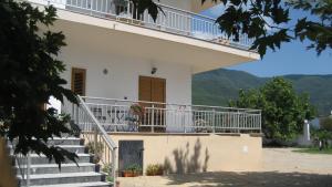a white house with stairs and a balcony at St Paul and Peter's House in Asprovalta