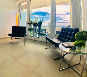 a living room with a couch and a table with a laptop at Blue City Apartments in Lübeck