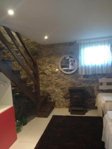 a bedroom with a staircase and a stone wall at Casa Carola in Oia