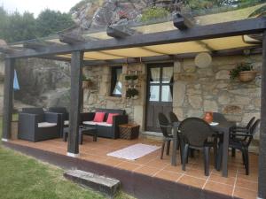 a patio with chairs and tables under a pergola at Casa Carola in Oia