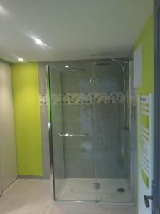 a shower with a glass door in a bathroom at Gîte climatisé *** Le Pigeonnier in Pons