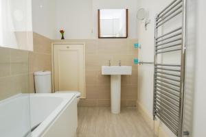 La salle de bains est pourvue d'un lavabo, de toilettes et d'un miroir. dans l'établissement No 5 - Central - by Brighton Holiday Lets, à Brighton et Hove