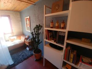 a living room with a couch and a book shelf at At Home in Arles in Arles