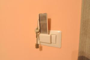 a key hanging from a lightswitch on a wall at Tartaglione in Caserta