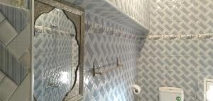 a bathroom with a mirror and a toilet at Appartements la grotte in Essaouira +70 photos