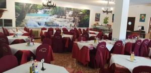 a banquet hall with tables and chairs in a room at Hostal Restaurante el cruce in Padul