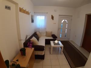 a living room with a couch and a table at House Jelena&Marija in Rakovica