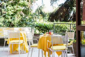 a table and chairs with a yellow table cloth at Aries in Lesa