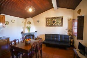 a living room with a table and a couch at Casas da Lagariça in Sortelha