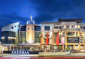 a building with cars parked in front of it at Astoria Luxury & SPA in Gjilan