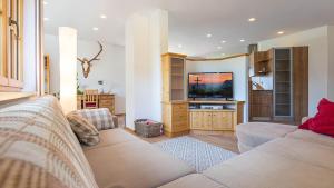 a living room with a couch and a flat screen tv at Apartment Neuper in Bad Mitterndorf