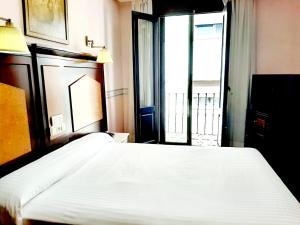 Postel nebo postele na pokoji v ubytování Hosteria Sara by gaiarooms