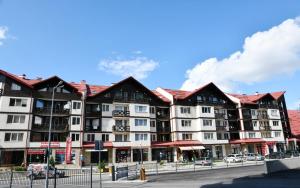 a large apartment building on a city street at Ski Apartment Boyika Iglika 2 in Borovets