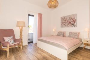 a bedroom with a bed and a chair and a window at BLUE Casa by VILLA HAHN in Puntagorda +29 photos