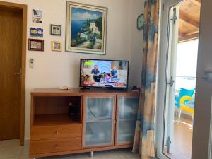 a tv sitting on top of a dresser in a room at Apartment Excellent in Nečujam