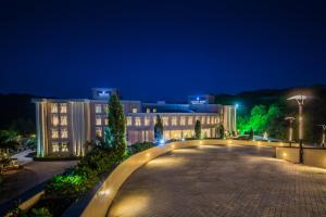 a view of a building at night with lights at Golden Tulip Chandigarh, Panchkula in Chandīgarh
