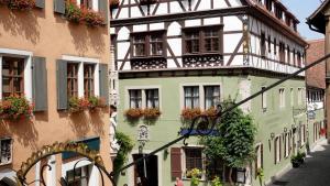 a street scene with a building and a street sign at Hotel Reichs-Küchenmeister in Rothenburg ob der Tauber