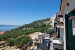a balcony with chairs and a view of the water at Apartments Denis in Makarska