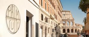 a building with a clock on the side of a street at Palm Suites - Small Luxury Hotels of the World in Rome
