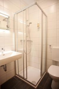 a bathroom with a shower and a sink at Gasthof Kummer in Podersdorf am See