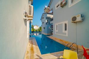 a view of a swimming pool between two buildings at Belek Akropolis Medusa Otel in Belek